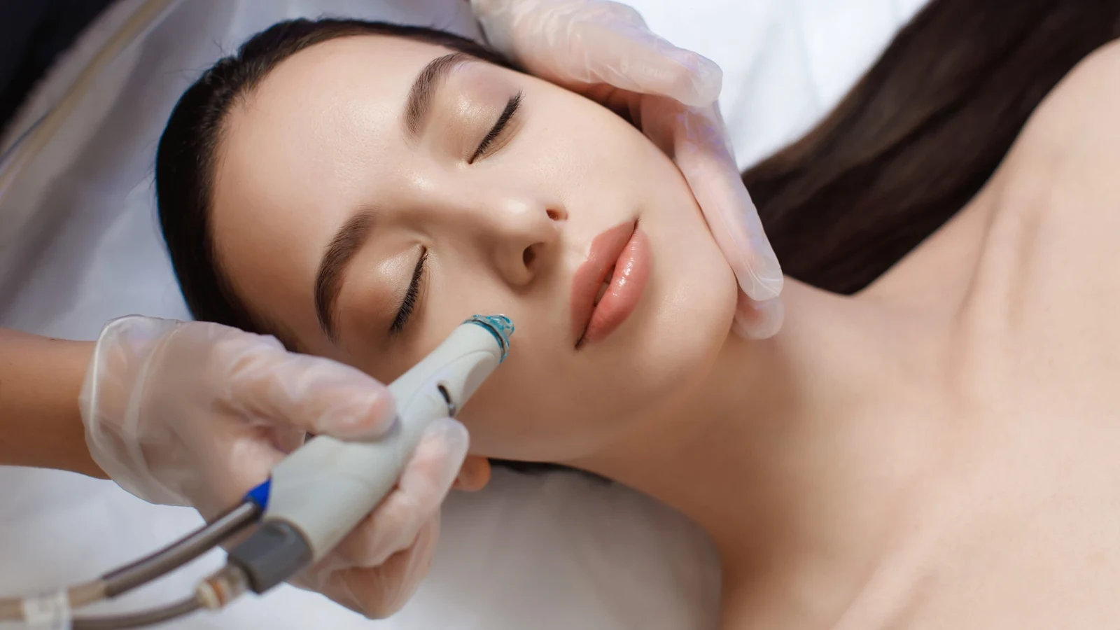 Hydrating facial treatment with a handheld skincare wand